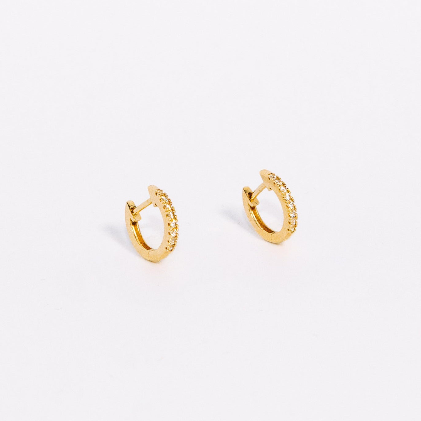 Gold hoop earrings on a white background