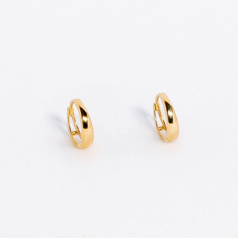 Gold hoop earrings on a white background