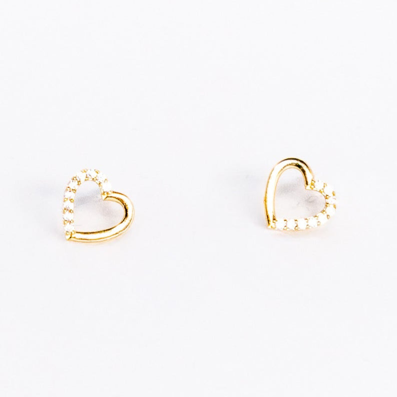 Heart-shaped gold earrings on a white background