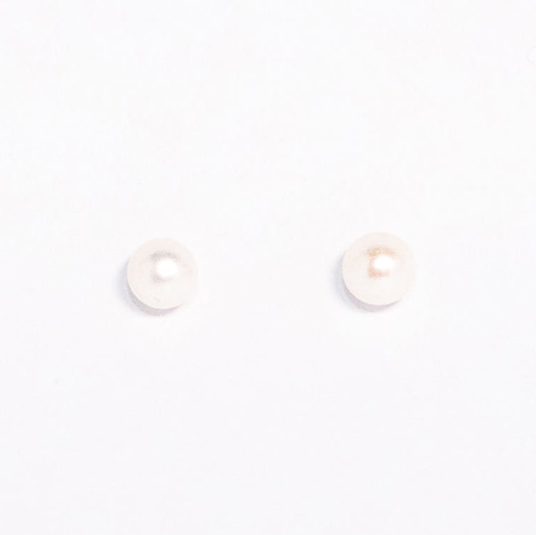 Pair of pearl stud earrings on a white background