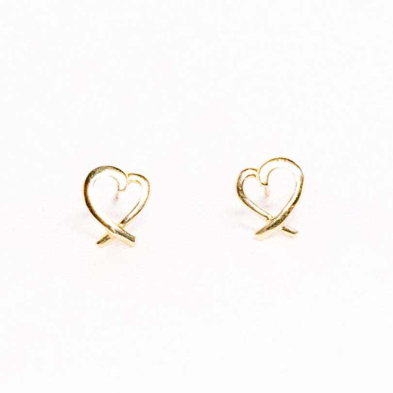 Heart-shaped gold earrings on a white background