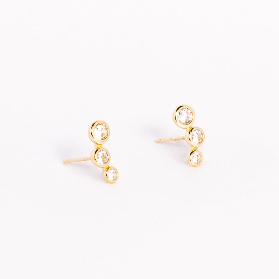 Pair of gold earrings on a white background