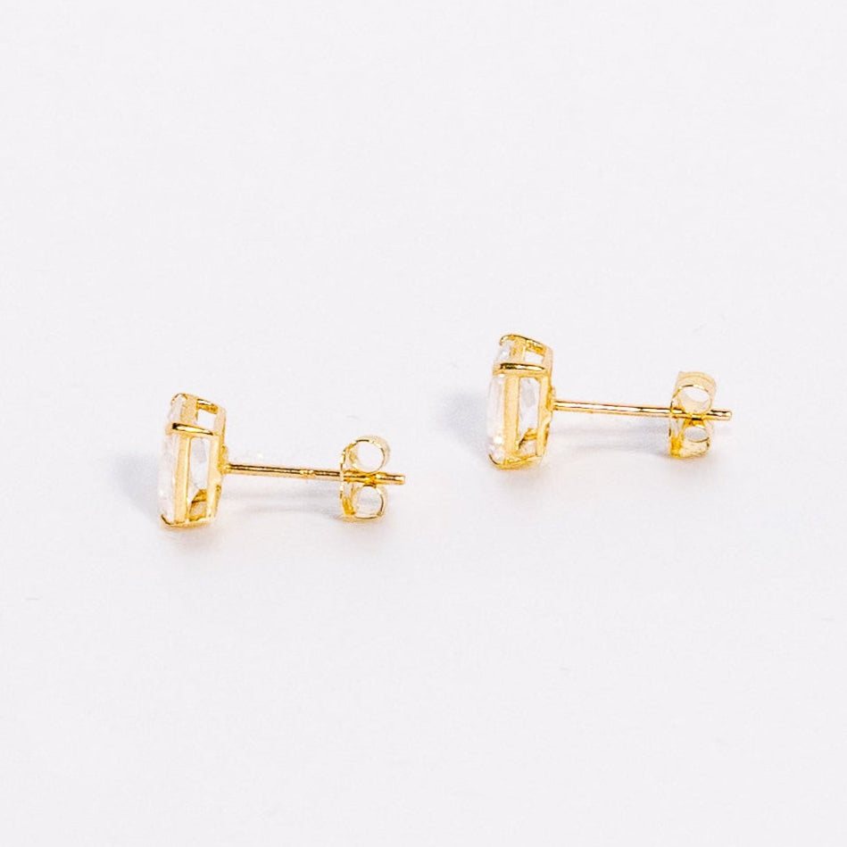 Pair of gold earrings on a white background