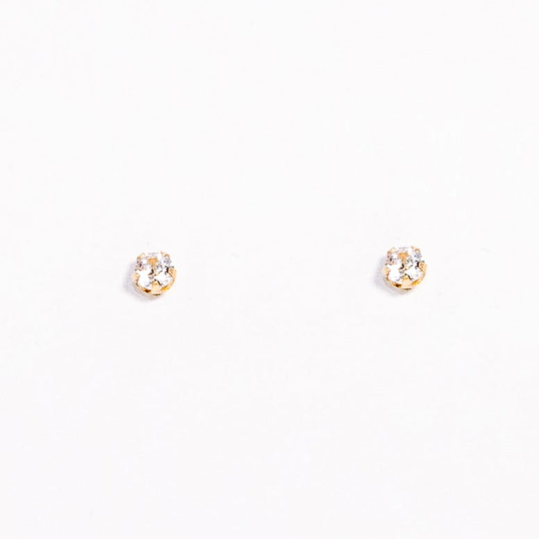 Small gold earrings on a white background