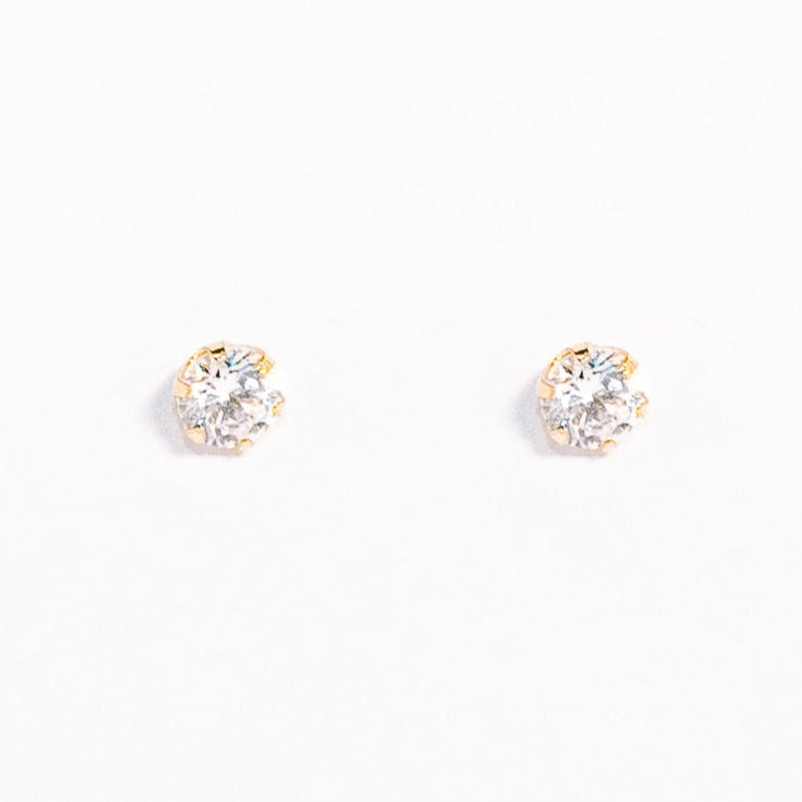 Pair of gold stud earrings on a white background