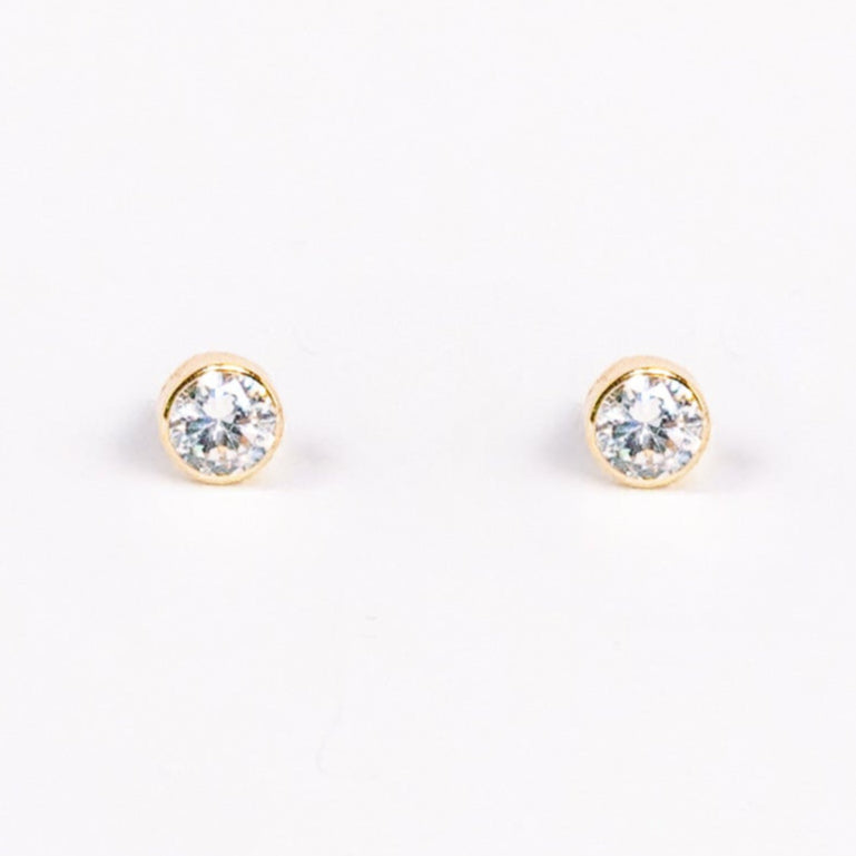Pair of gold stud earrings on a white background