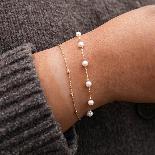 Pearl bracelet on a wrist with a blurred background