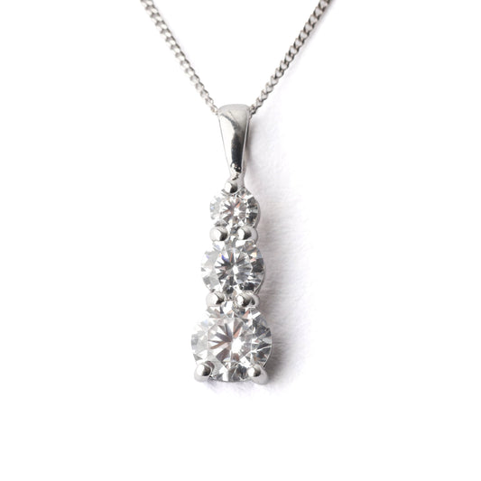 Diamond pendant on a chain against a white background