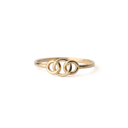 Women's solid gold ring featuring three interlocking circles displayed on a white background