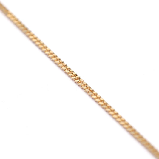 Women's 9K solid yellow gold diamond cut curb chain necklace on a white background