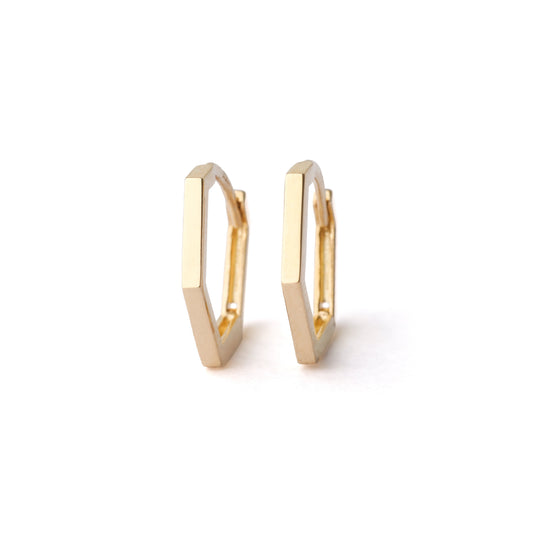 A pair of women's solid gold 13mm hexagonal hoop earrings on a white background