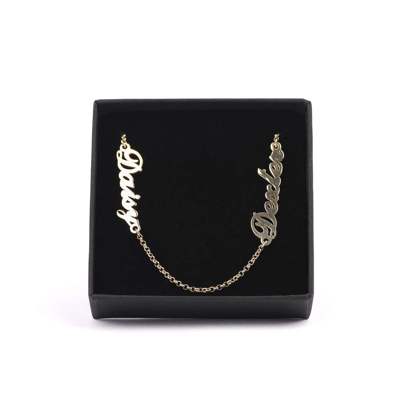 Women's solid gold necklace with children's names engraved, sitting in a black jewellery box on a white background
