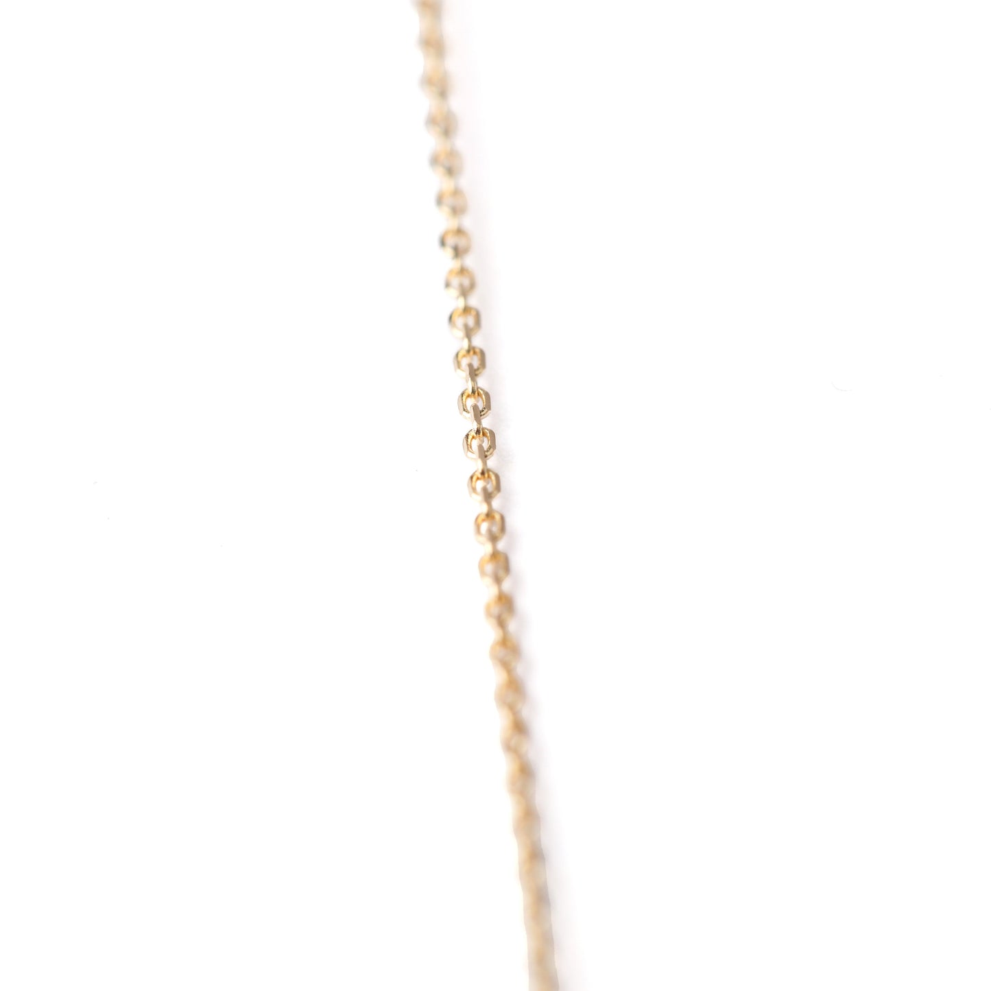 Women's 10K solid yellow gold thin link chain bracelet on a white background