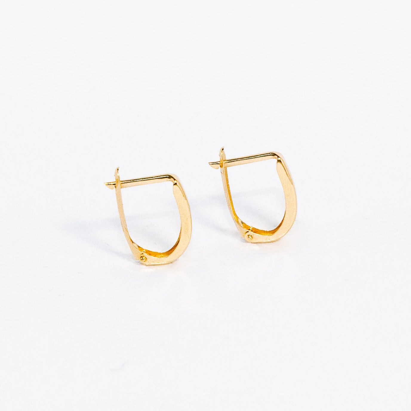 Gold hoop earrings on a white background