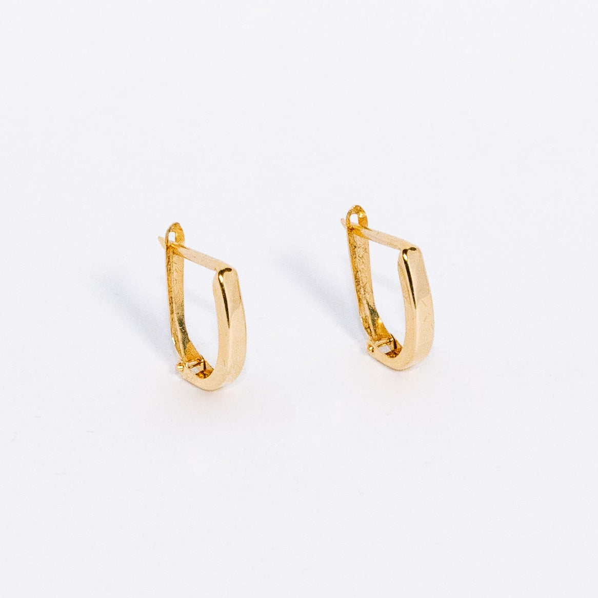 Gold hoop earrings on a white background
