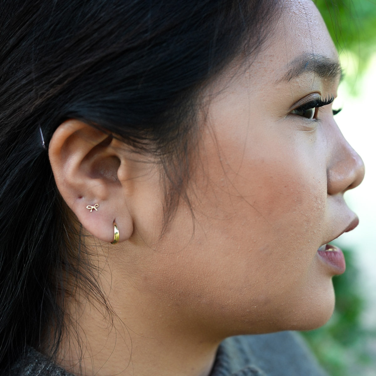 Close-up of a woman's profile with gold earrings.