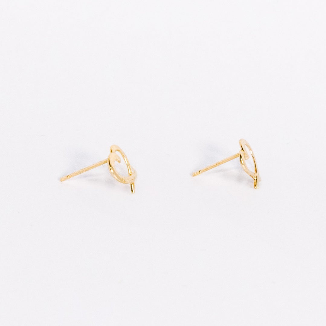 Pair of gold earrings on a white background