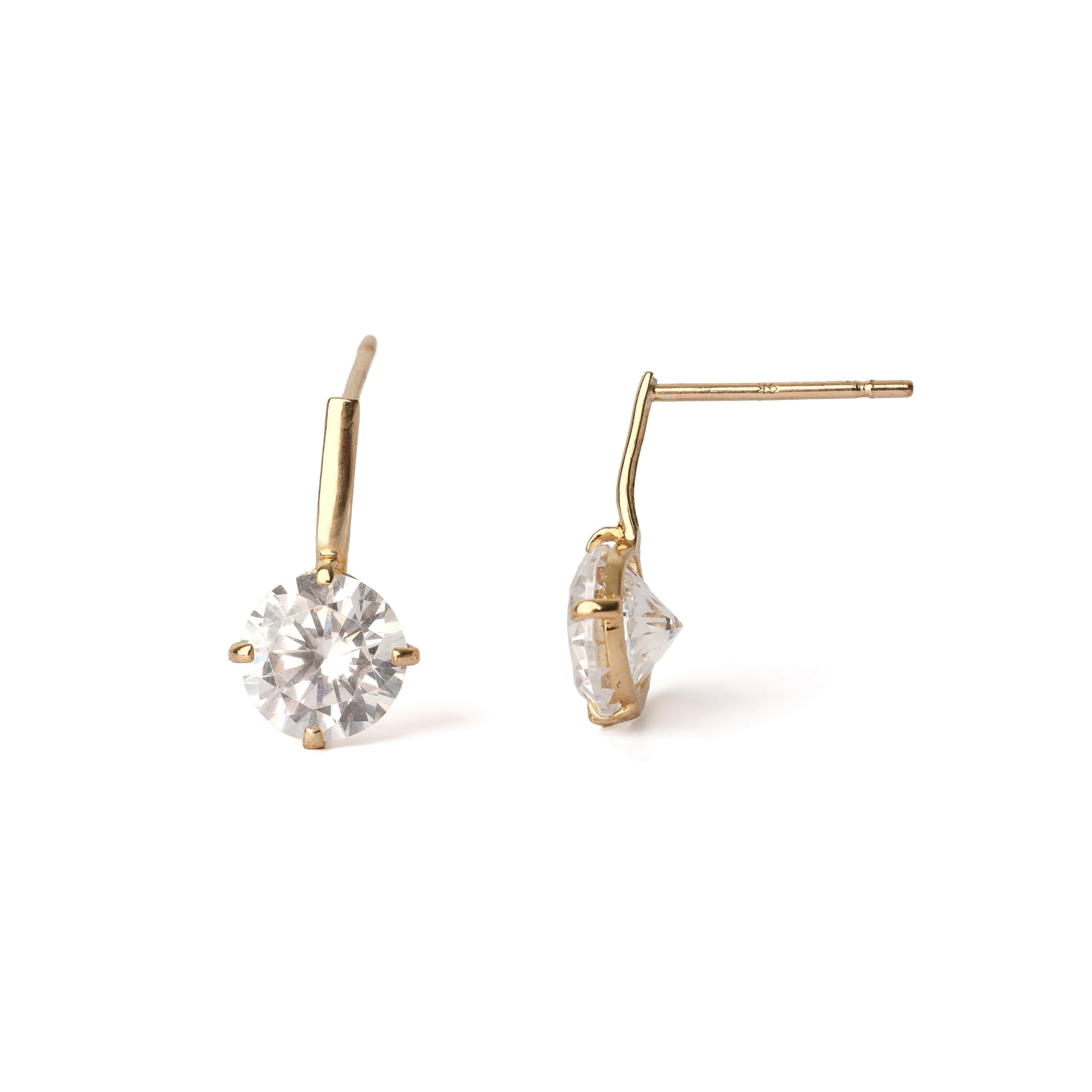 Gold stud earrings with clear gemstones on a white background
