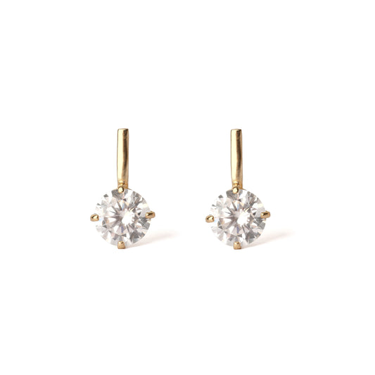 Pair of gold earrings with clear gemstones on a white background