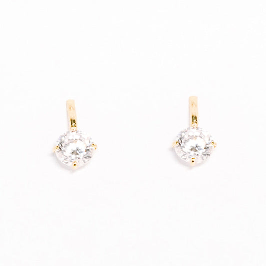 Gold earrings with clear gemstones on a white background