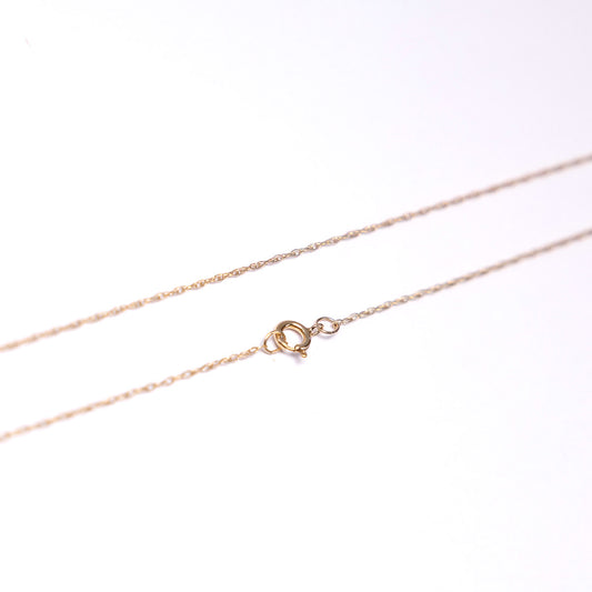 Rose gold chain necklace on a white background