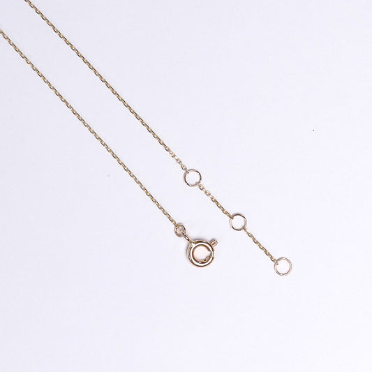 Rose gold necklace on a light gray background