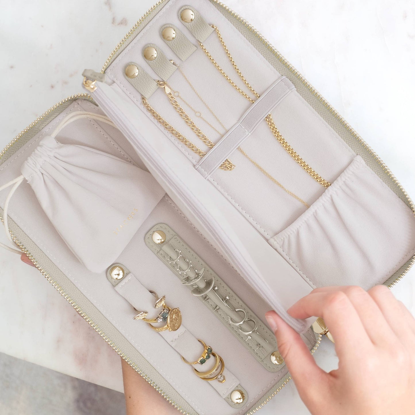 Jewelry organizer with gold jewelry on a white background