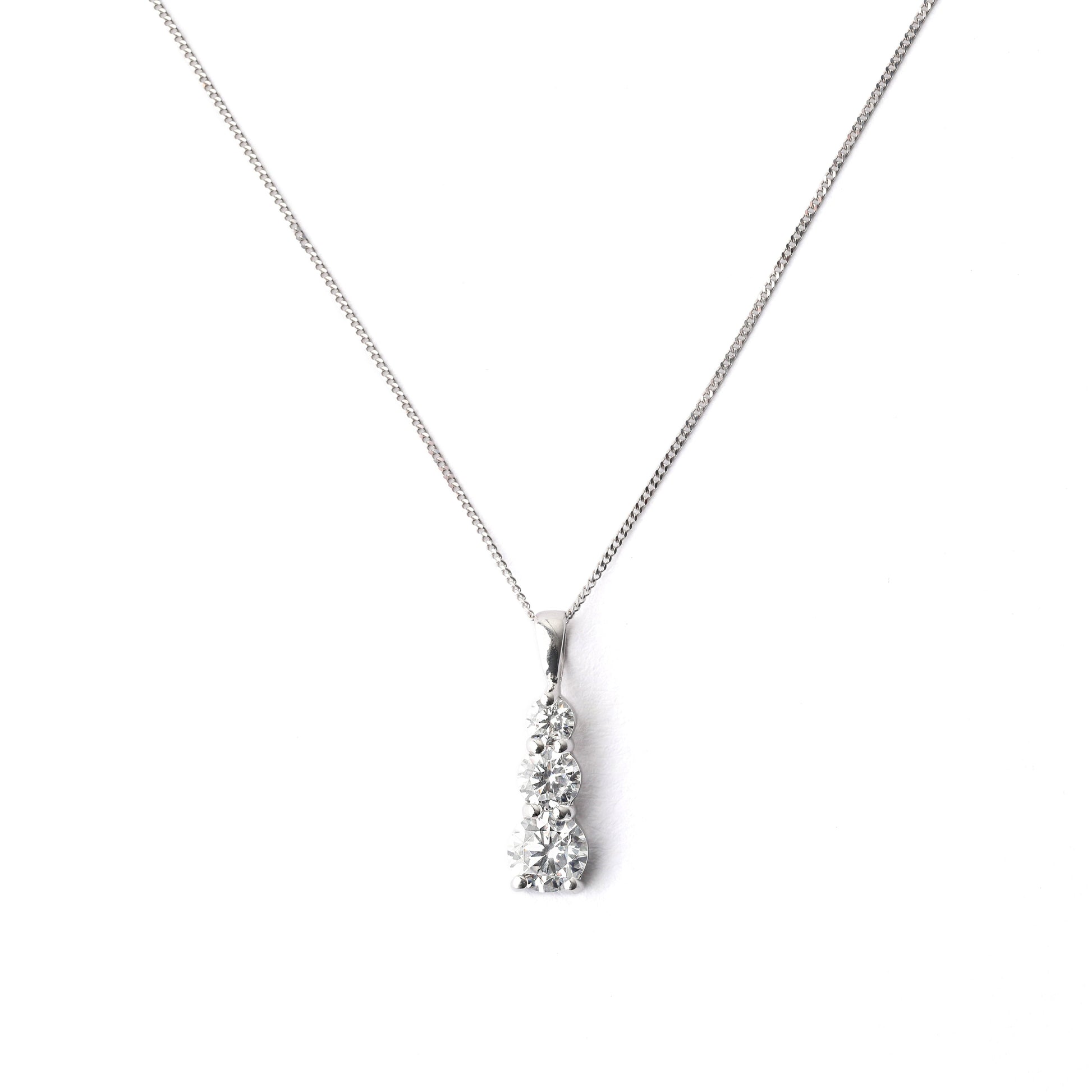 Women's 9K solid white gold chain and pendant necklace set with three cubic zirconia on a white background