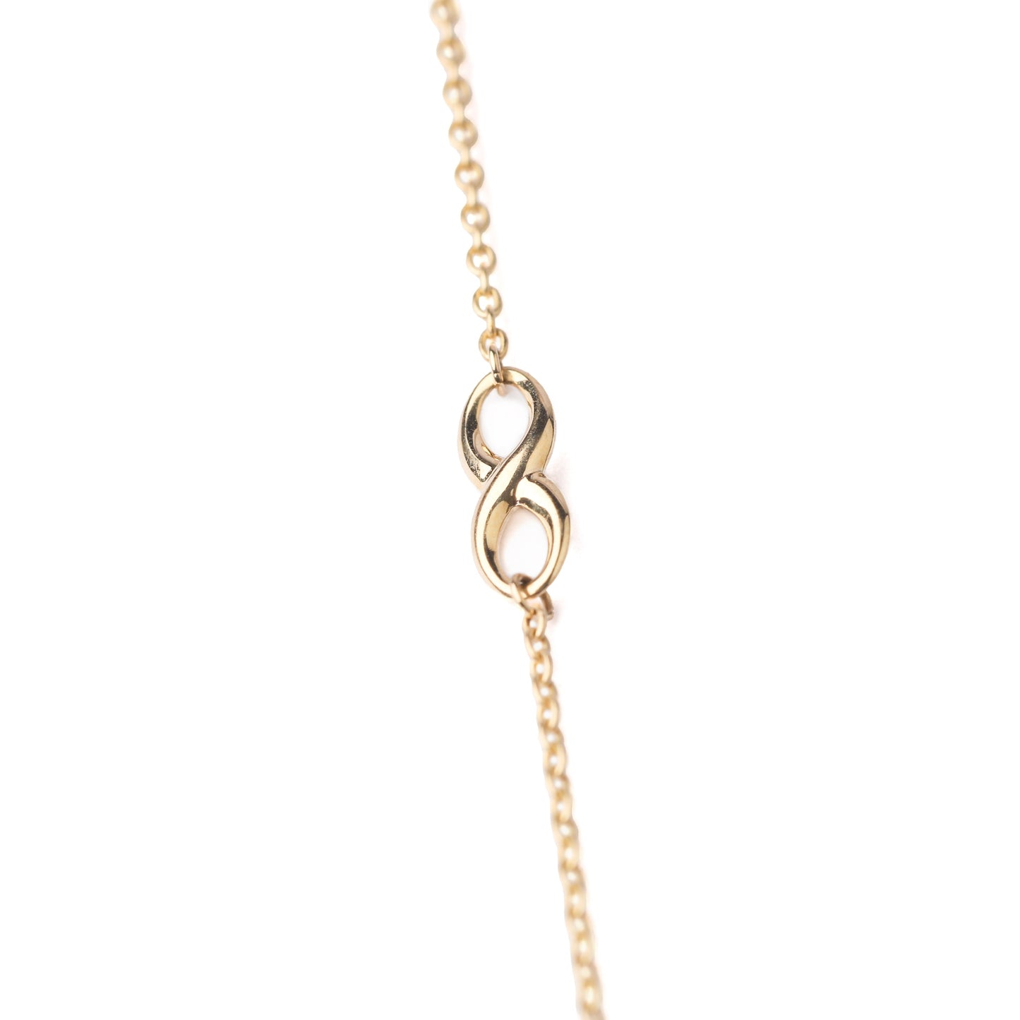 Women's 9K solid yellow gold bracelet with infinity symbol in the chain on a white background