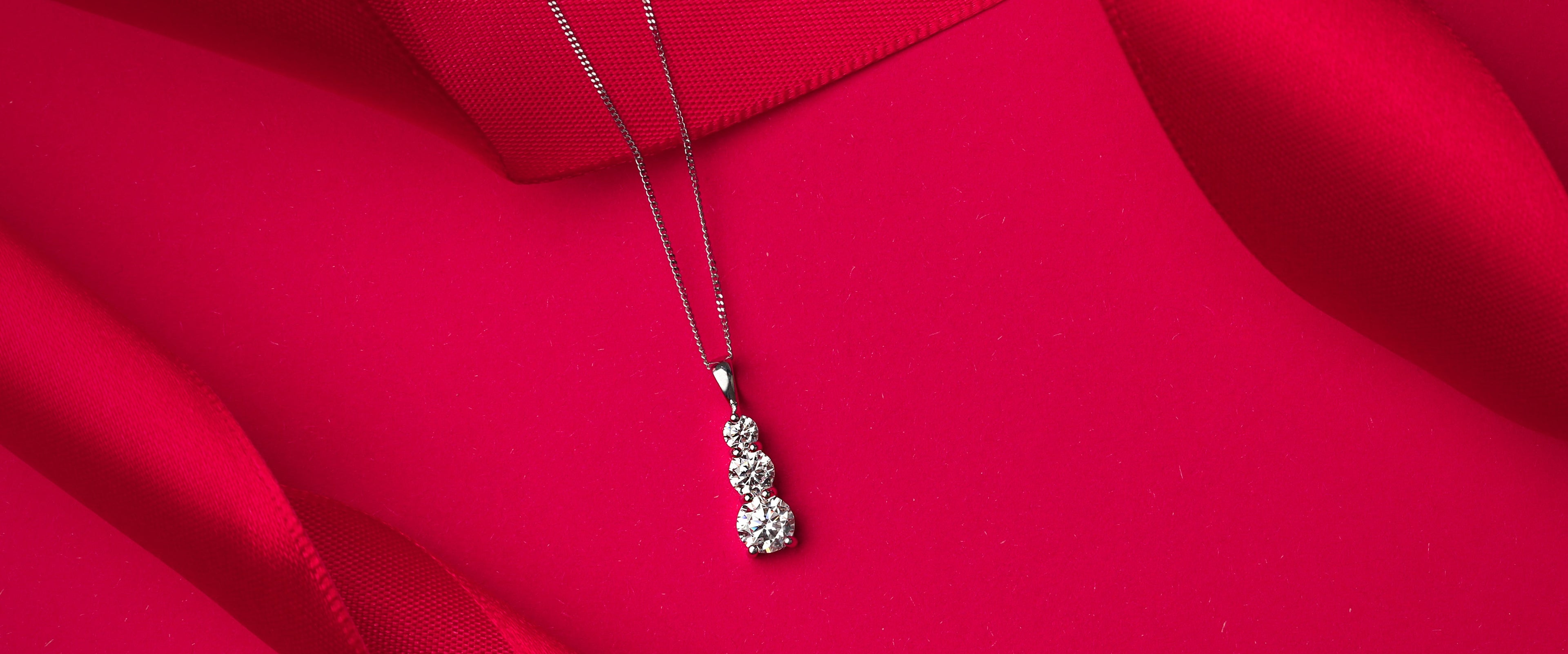 Necklace with a pendant on a red fabric background
