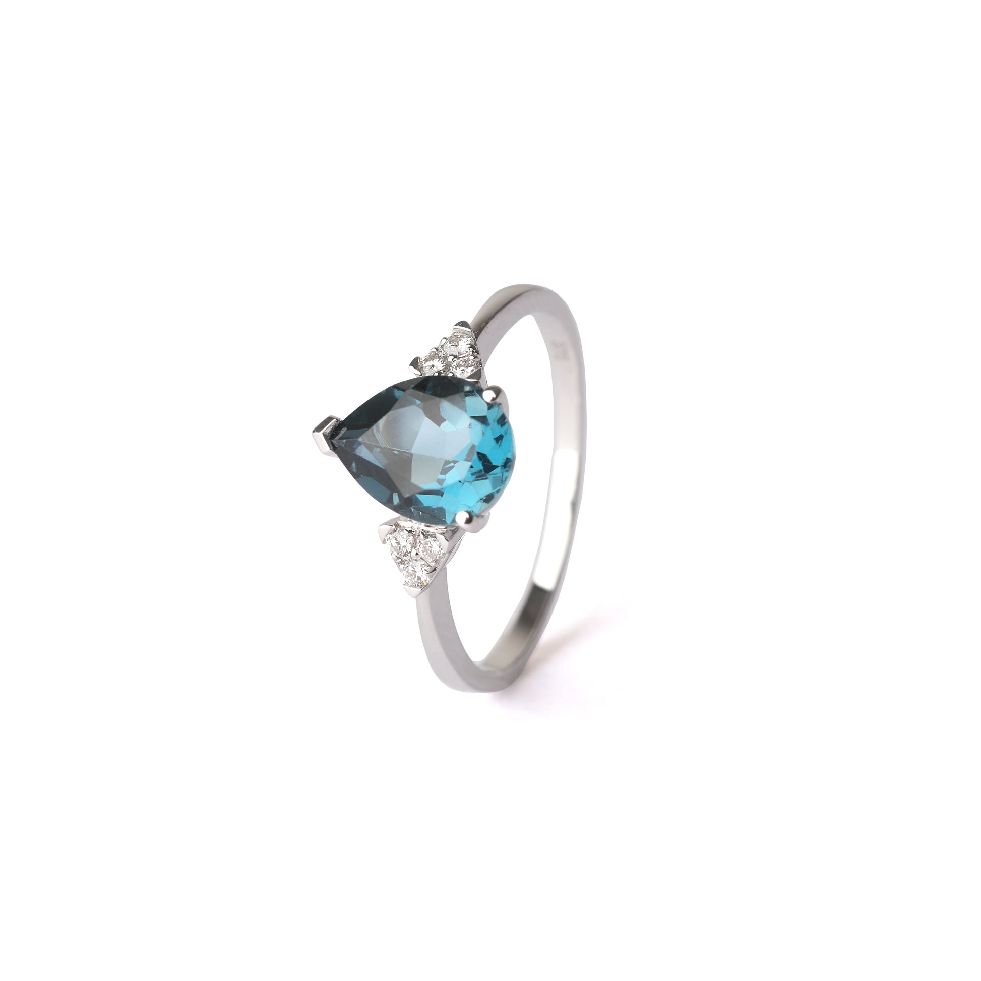 Women's white gold ring set with a large London blue topaz gemstone surrounded by three small diamonds either side, displayed on a white background at a side angle.