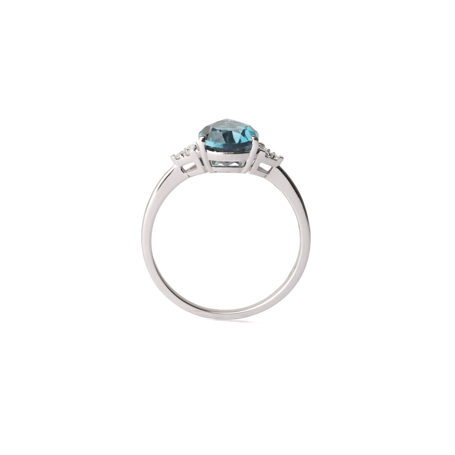 Women's white gold ring set with three small diamonds either side of a large pair shape London blue topaz gemstone, displayed on a white background.