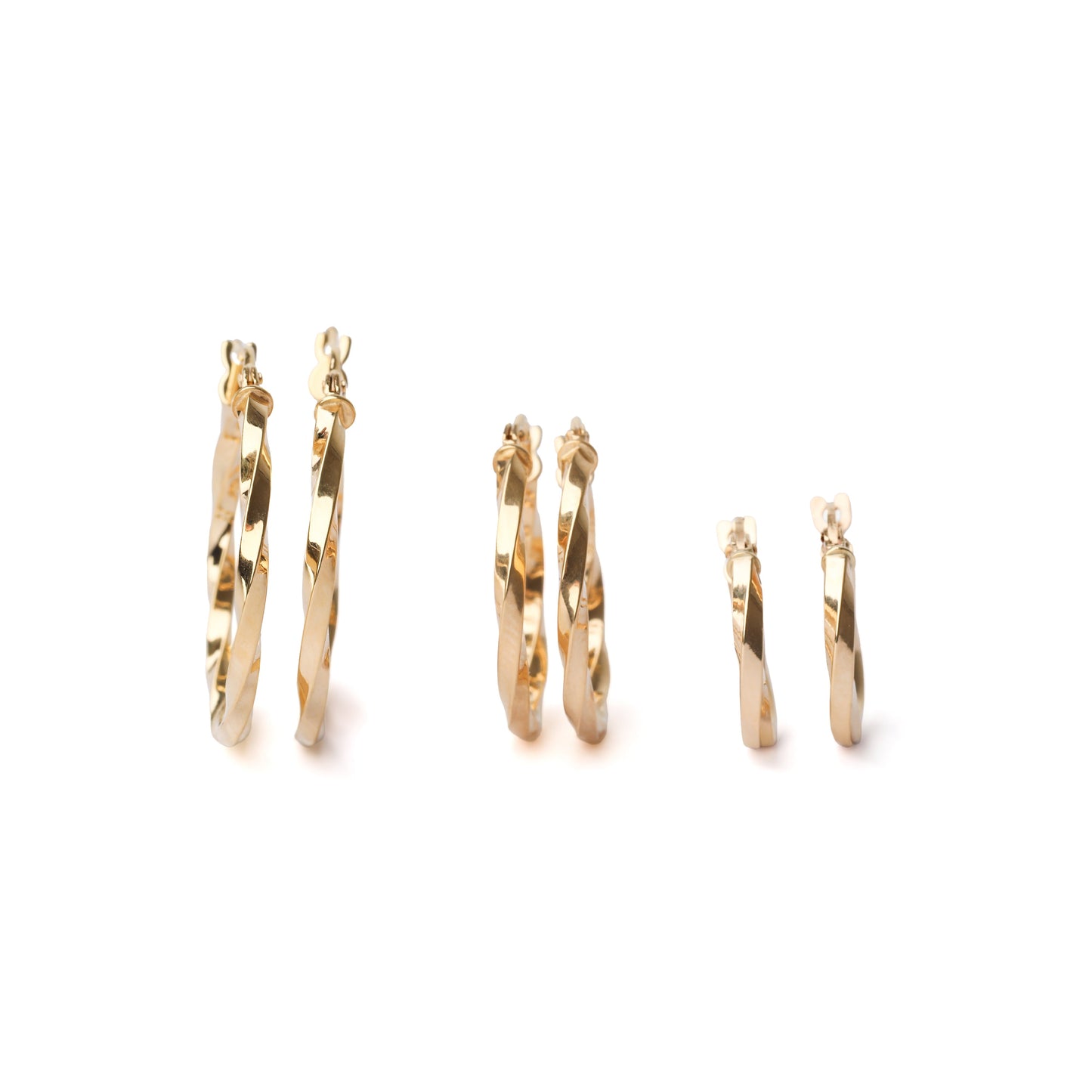 Set of gold hoop earrings on a white background