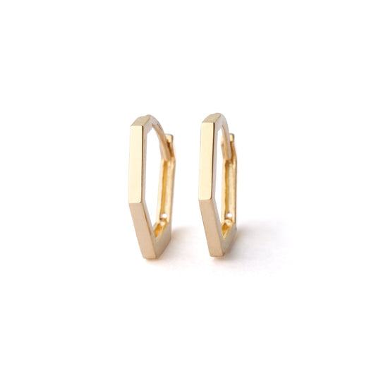 Gold hoop earrings on a white background