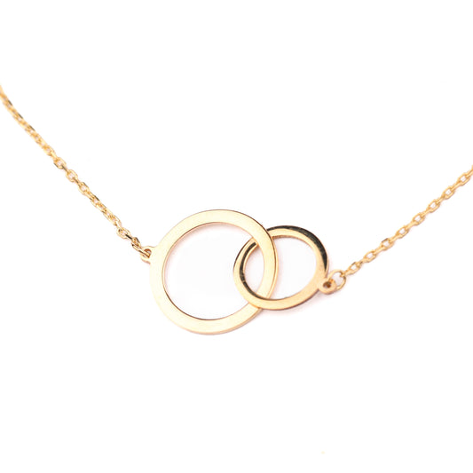 Gold necklace with interlocking rings on a white background