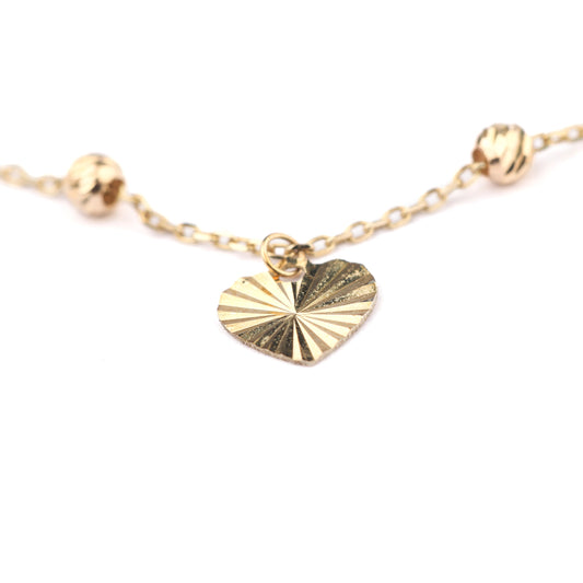 Gold heart-shaped pendant necklace on a white background