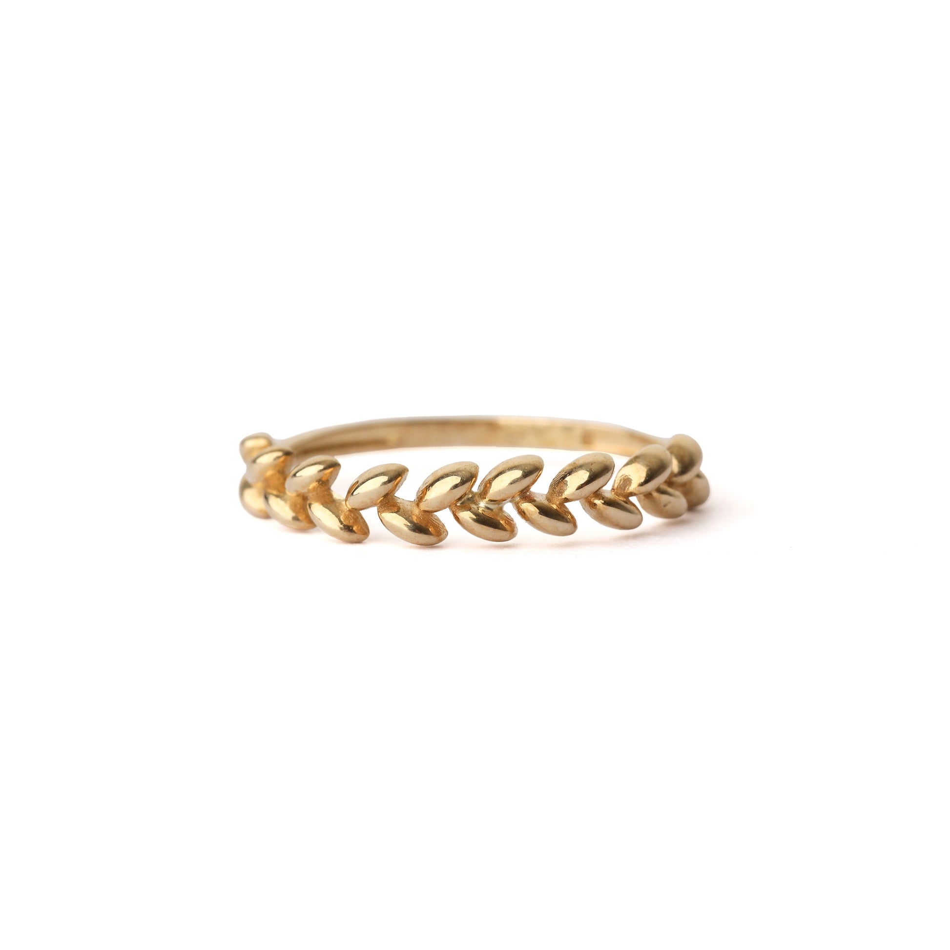 Women's solid yellow gold ring with a leaf design, displayed on a white background