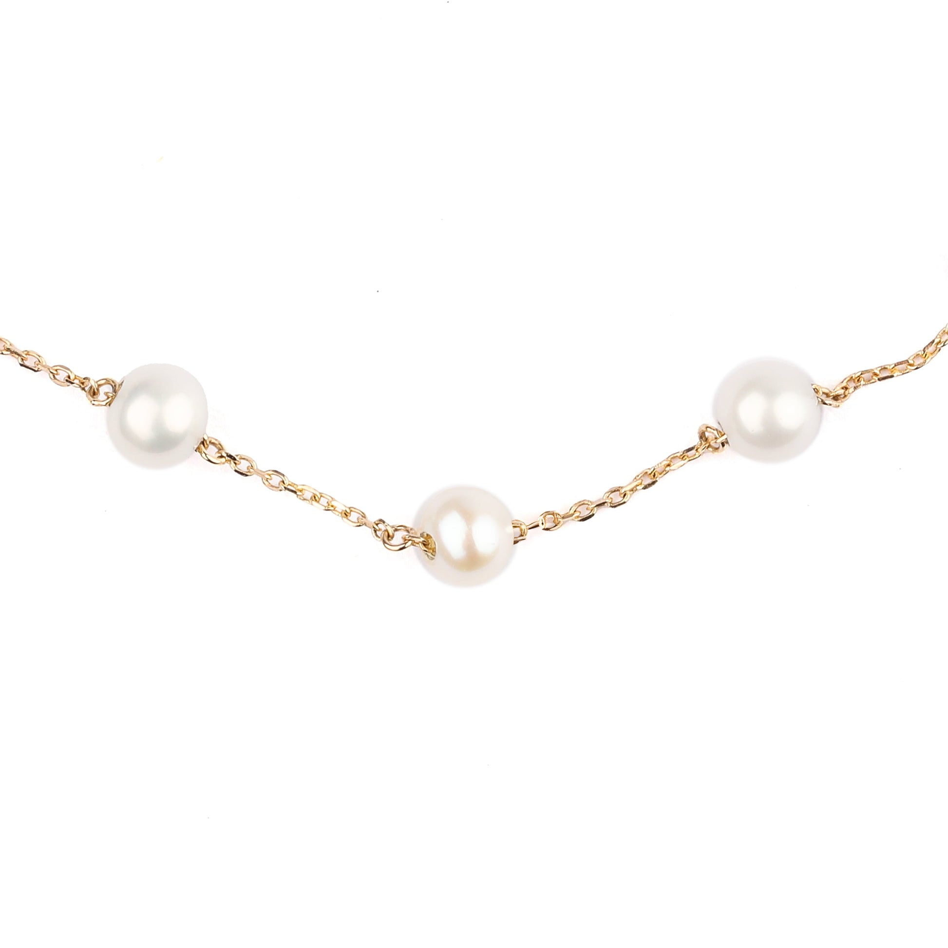 Part of a women's solid yellow gold chain bracelet decorated with three freshwater pearls displayed on a white background