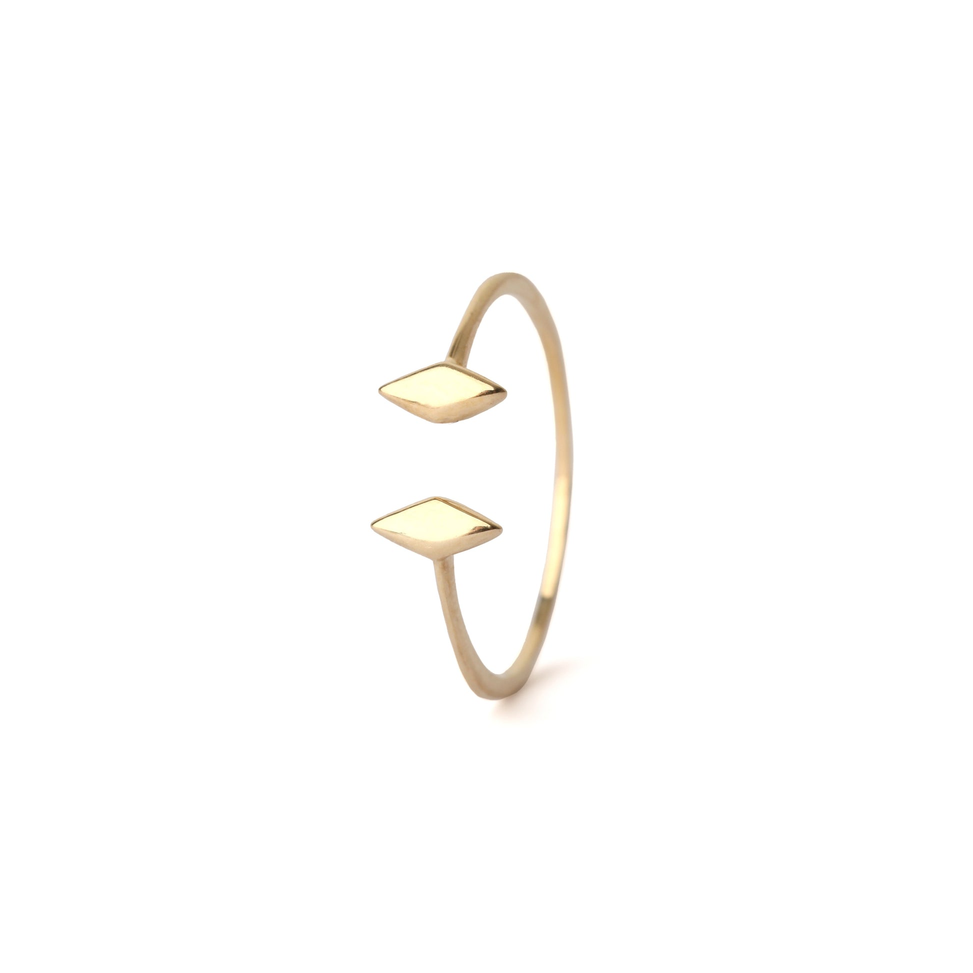 Women's solid yellow gold gap ring with diamond shape ends displayed on a white background