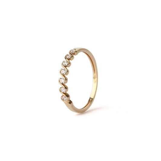 Women's solid yellow gold wave ring set with small cubic zirconia gemstones between the waves, displayed on a white background