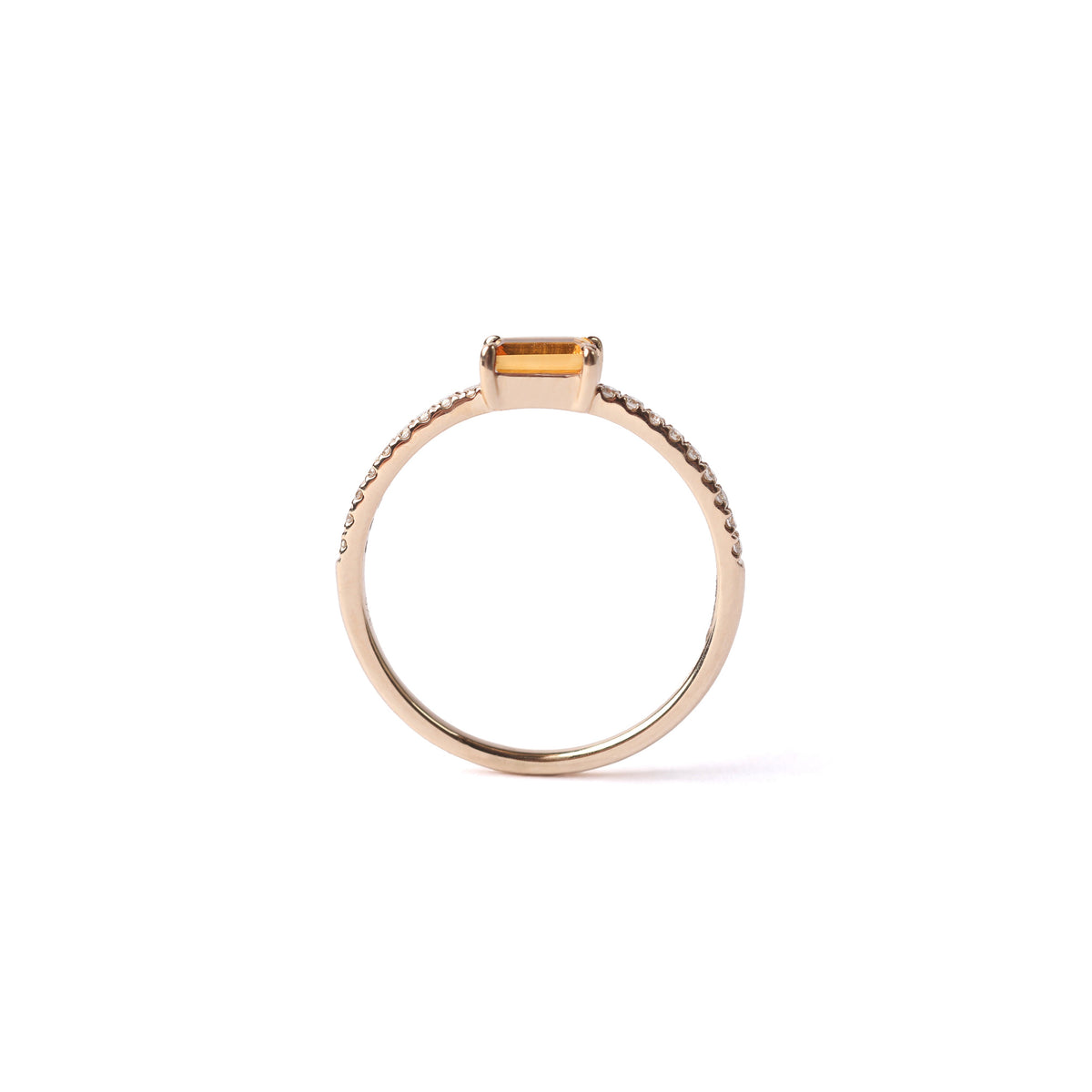 Women's solid yellow gold ring set with a central yellow citrine gemstone and small round diamonds on the shoulders each side of the citrine, displayed on a white background upright and side on.