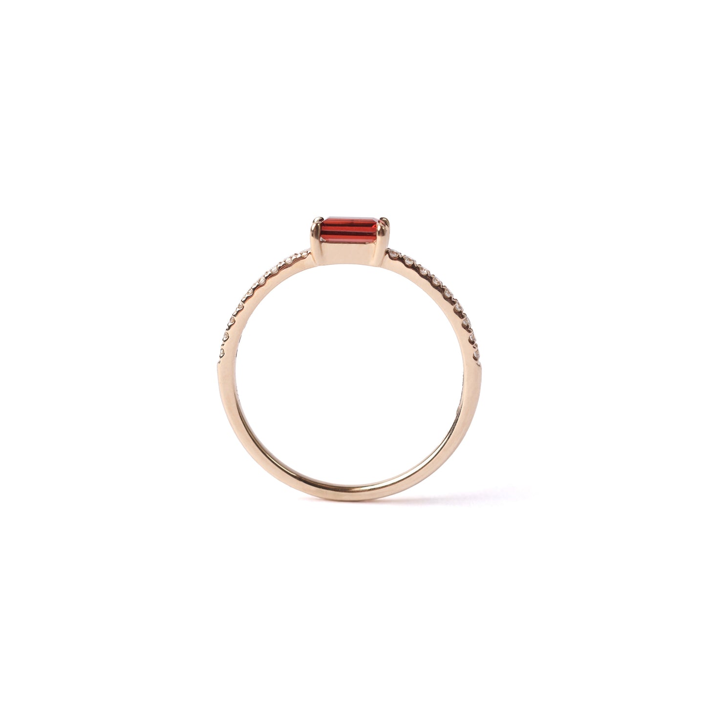 Women's solid yellow gold ring with a rectangular red garnet set as the centre stone, with small round diamonds set into the shoulders of the ring, displayed sideways on a white background.