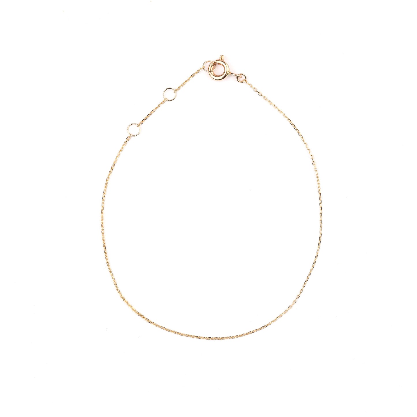 Women's 10K solid yellow gold thin link chain bracelet on a white background