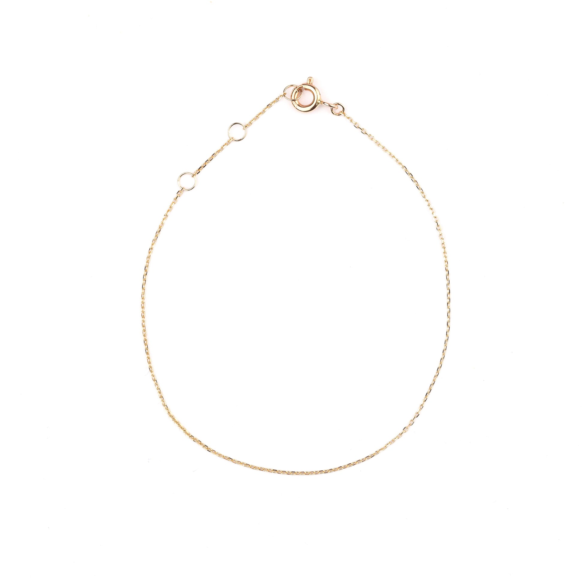 Women's 10K solid yellow gold thin link chain bracelet on a white background