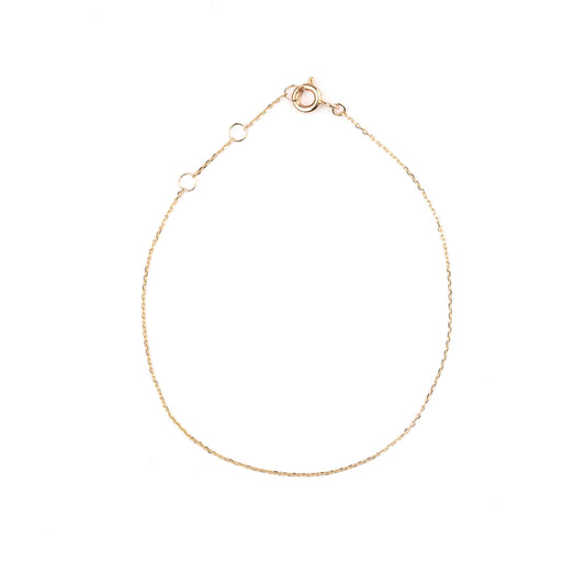 Women's 10K solid yellow gold thin link chain bracelet on a white background