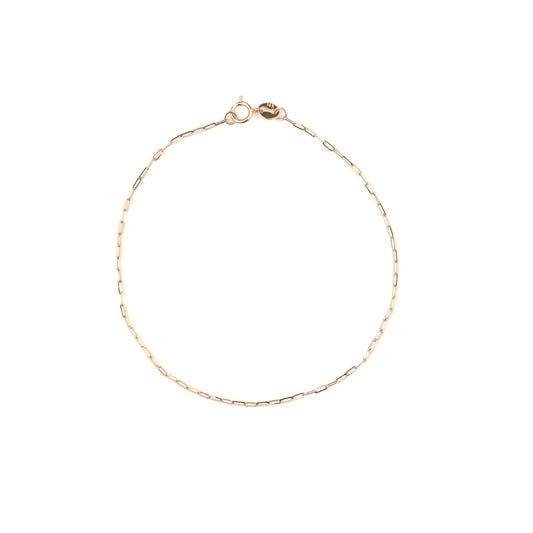 Women's solid gold paperclip chain bracelet on a white background