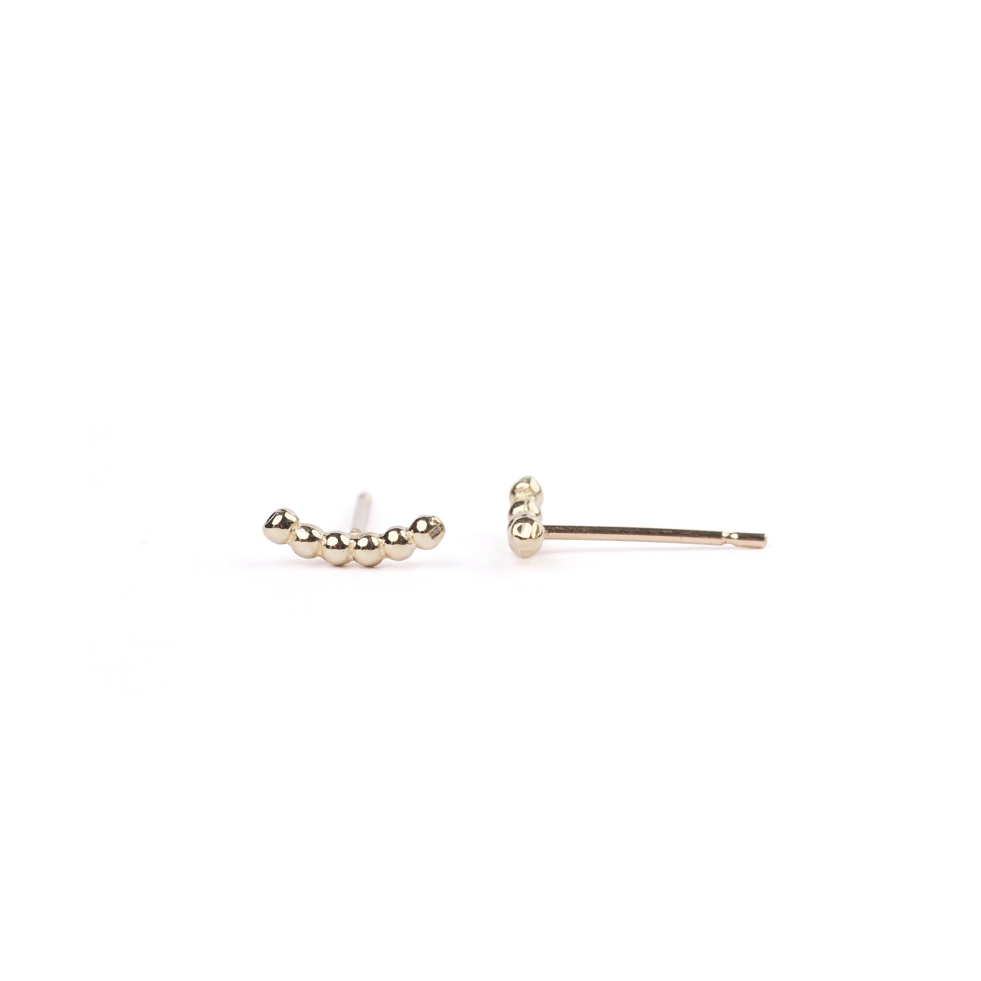 A pair of women's solid yellow gold bead climber earrings on a white background