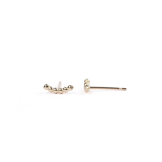 A pair of women's solid yellow gold bead climber earrings on a white background