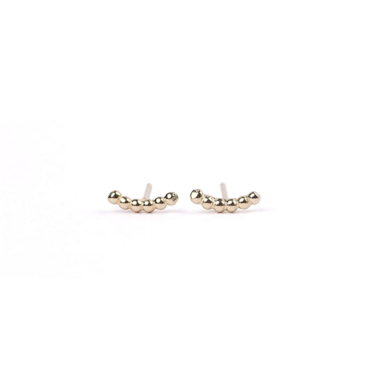 A pair of women's yellow gold bead climber stud earrings on a white background
