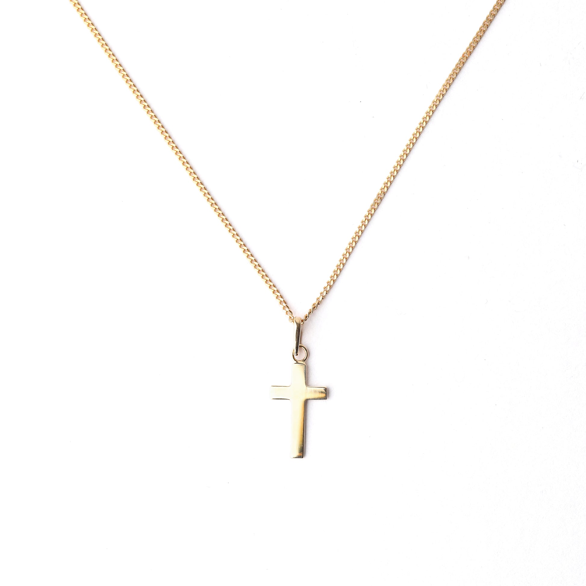 Women's 9K solid yellow gold cross pendant and necklace on a white background